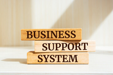 Wooden blocks with words 'Business Support System'. Business concept.