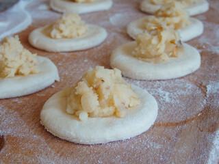 Cooking dumplings stuffed with yeast dough. Making traditional dumplings