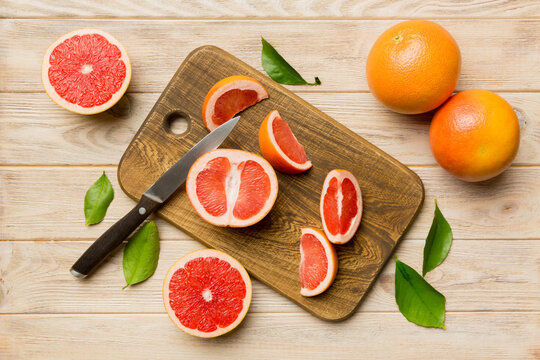 fresh Fruit grapefruit slices on colored background. Top view. Copy Space. creative summer concept. Half of citrus in minimal flat lay with copy space