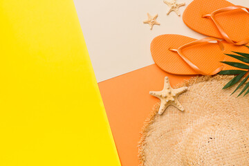 Summer vacation concept flat lay. straw hat beach accessories and flip flop top view. Space for...