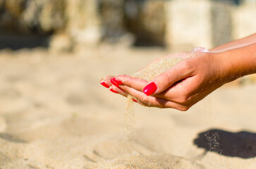 sand through fingers on the beach