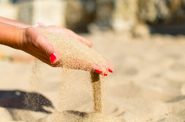 sand through fingers on the beach