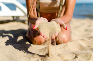 sand through fingers on the beach