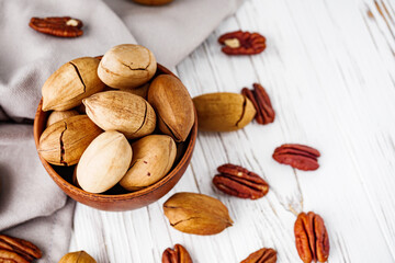 delicious fresh pecans on a white wooden rustic background