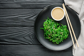 fresh delicious Chukka Wakame salad on a black wooden rustic background