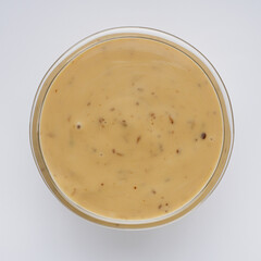 sesame tahini paste on a white acrylic background