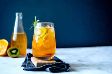 Fruit lemonade. Orange lemonade. Kiwi lemonade. Summer lemonade. Lemonade on a wooden board.