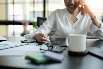 Close up business woman hand holding stylus pen and digital tablet for planning working schedule in office