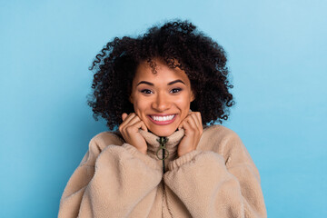 Portrait of positive lady hold artificial fur outfit cold weather enjoy fresh softness isolated blue color background © deagreez