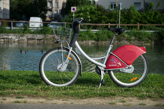 Mulhouse - France - 12 May 2022 - Profile view of rental citybike parked in a public garden