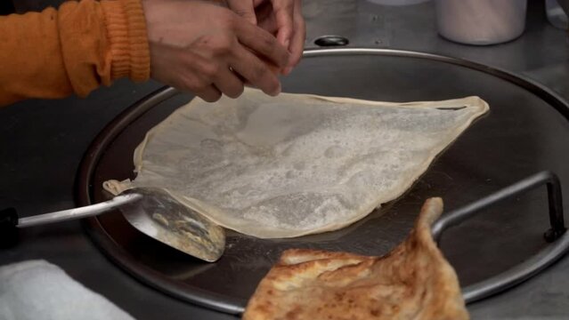 Making traditional Indian food called 'Roti Canai', slow motion
