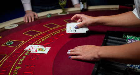 People play poker roulette at the table. Friends playing in the casino. A group of young people at...