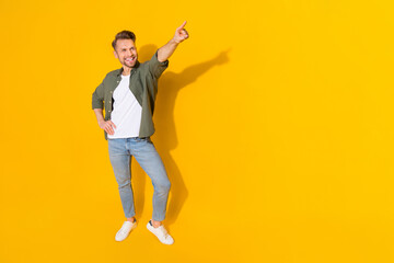 Fototapeta na wymiar Full length body size view of attractive cheerful guy dancing moving spend evening isolated over bright yellow color background