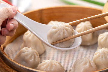Steamed pork soup dumplings named Xiao long bao in Taiwan.