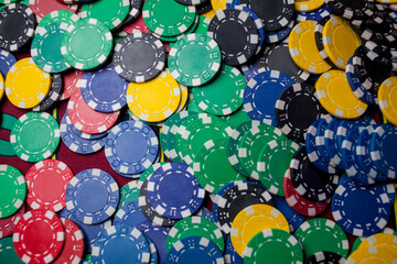 Poker chips colorful gaming pieces lie on the game table in the stack. Background for gambling,...