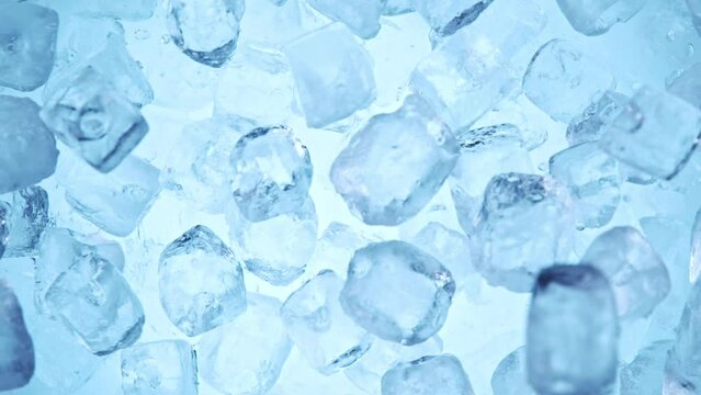Super slow motion of falling ice cubes separated on blue background. Filmed on high speed cinema camera, 1000 fps.