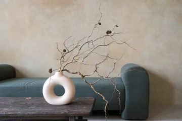 Fotobehang Boho Dry branches in ceramic vase on vintage table  © brizmaker