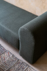 Soft couch and carpet in room with beige walls