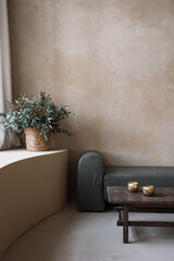 Modern soft couch, bronze bowls and decorative flowers