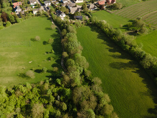 aerial drone flight over green meadows and forest in lower austria