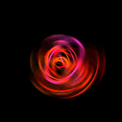 Spinning rays of light isolated on black background. Graphic 2D illustration of glowing colorful light particles in circular motion.