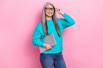 Photo of intelligent successful lady touch eyewear hold netbook isolated on pink color background