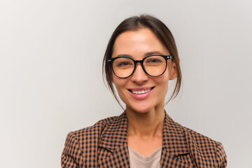 Portrait view of the confident beautiful asian woman teacher wearing glasses posing isolated over...