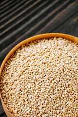 white quinoa seeds on a dark rustic background