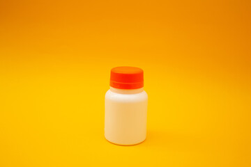 Jar with pills on a yellow background