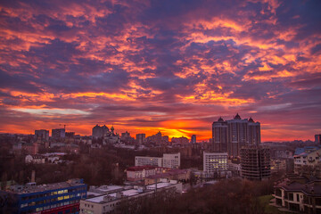 Fototapeta premium Ukraine, Kyiv – November 26, 2016: Aerial panoramic view on central part of Kyiv city, residential area at sunset. Stunning sunset, golden hour. Lukianivska area. City silhouettes. 