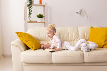 Baby with cochlear implants at home. Deafness and medical technology concept.