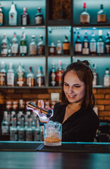 young attractive woman bartender Making Cocktail in bar
