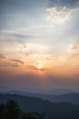 Fototapeta na wymiar Sunset in the mountains in Pai, Thailand. Smog from the burning season.