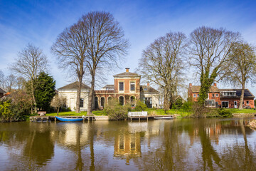 Fototapeta na wymiar Historic houses at the Winsumerdiep river in Onderdendam, Netherlands