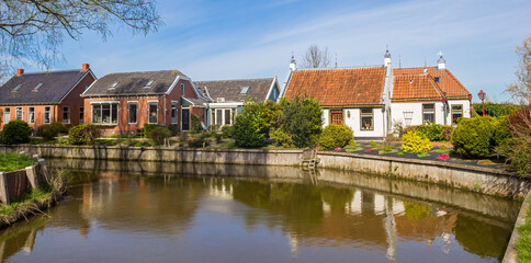 Fototapeta na wymiar Panorama of historic houses at the canal in Middelstum, Netherlands