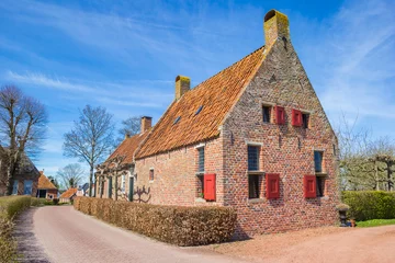 Deurstickers Historic house on top of the hill in Groot Wetsinge, Netherlands © venemama