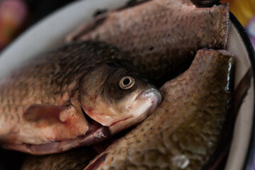 Silver crucians in a plate, cleaned and ready to be cooked