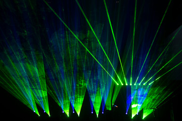 Laser show beams. Many colorful rgb lazer light beams at a concert or a rave party show. Night club...