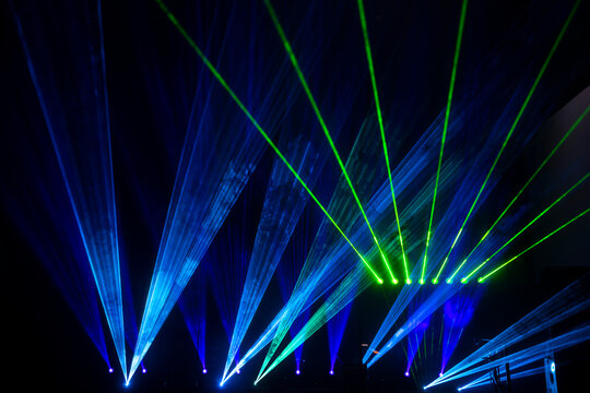 Laser show beams. Many colorful rgb lazer light beams at a concert or a rave party show. Night club flayer design background