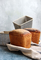 Rectangular bread and aluminum forms on a table. Freshly homemade baked rye bread close up photo. 