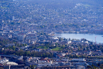 Panoramic view over City of Zurich with lake Zurich seen from local mountain Uetliberg on a summer day morning. Photo taken April 14th, 2022, Zurich, Switzerland.