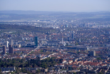 Panoramic view from local mountain Uetliberg over City of Zürich on a blue cloudy spring day. Photo taken April 14th, 2022, Zurich, Switzerland.