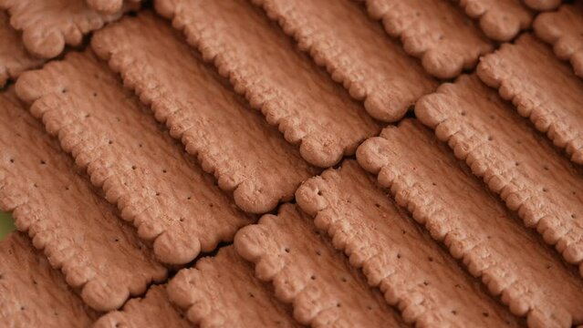 Close-up view 4k stock video footage of tasty crispy brown chocolate biscuits cookies isolated. Abstract food video background
