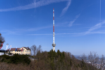 Obraz premium Communications tower at local mountain Uetliberg on a blue cloudy spring day. Photo taken April 14th, 2022, Zurich, Switzerland.