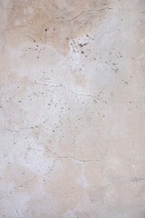 Beige wall with cracks. Wall of the house. Home repairs. Construction. Texture and background