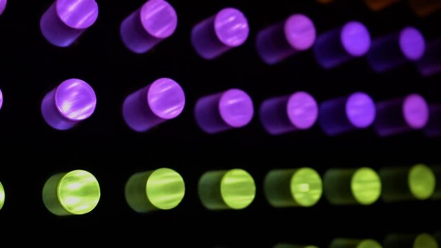 Abstract neon colorful cylinders with luminous bulbs, light music.