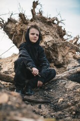 A boy walks among cut down trees. Russia.