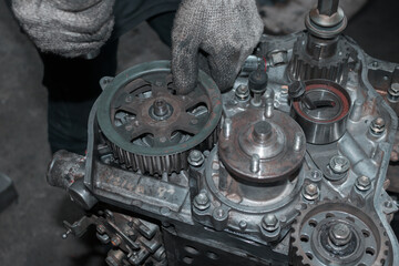 The mechanic is checking the engine.