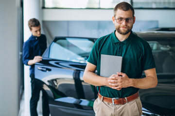 Man buying a car in a car showroom