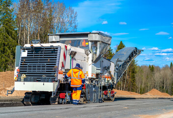 Road milling machine, scraper removes the old layer of asphalt from the road surface. Road...